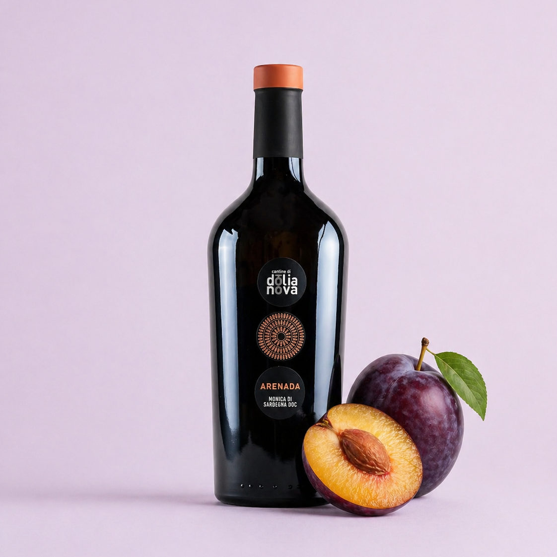 Arenada Monica di Sardegna red wine bottle with fresh plum on a soft light background