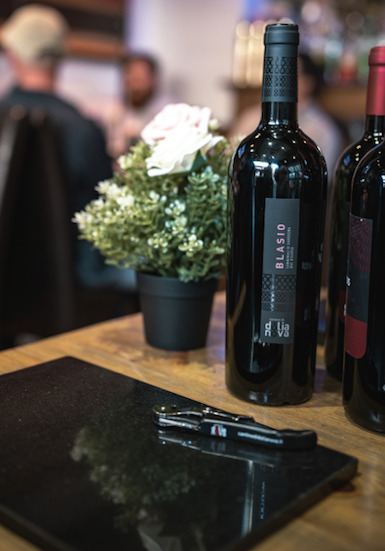 Blasio Cannonau di Sardegna Riserva bottle on table with corkscrew