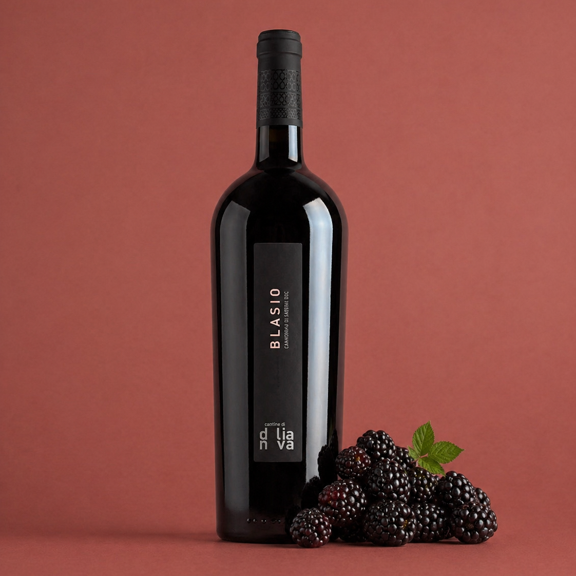 Blasio Cannonau di Sardegna Riserva red wine bottle with fresh blackberries on a deep red background