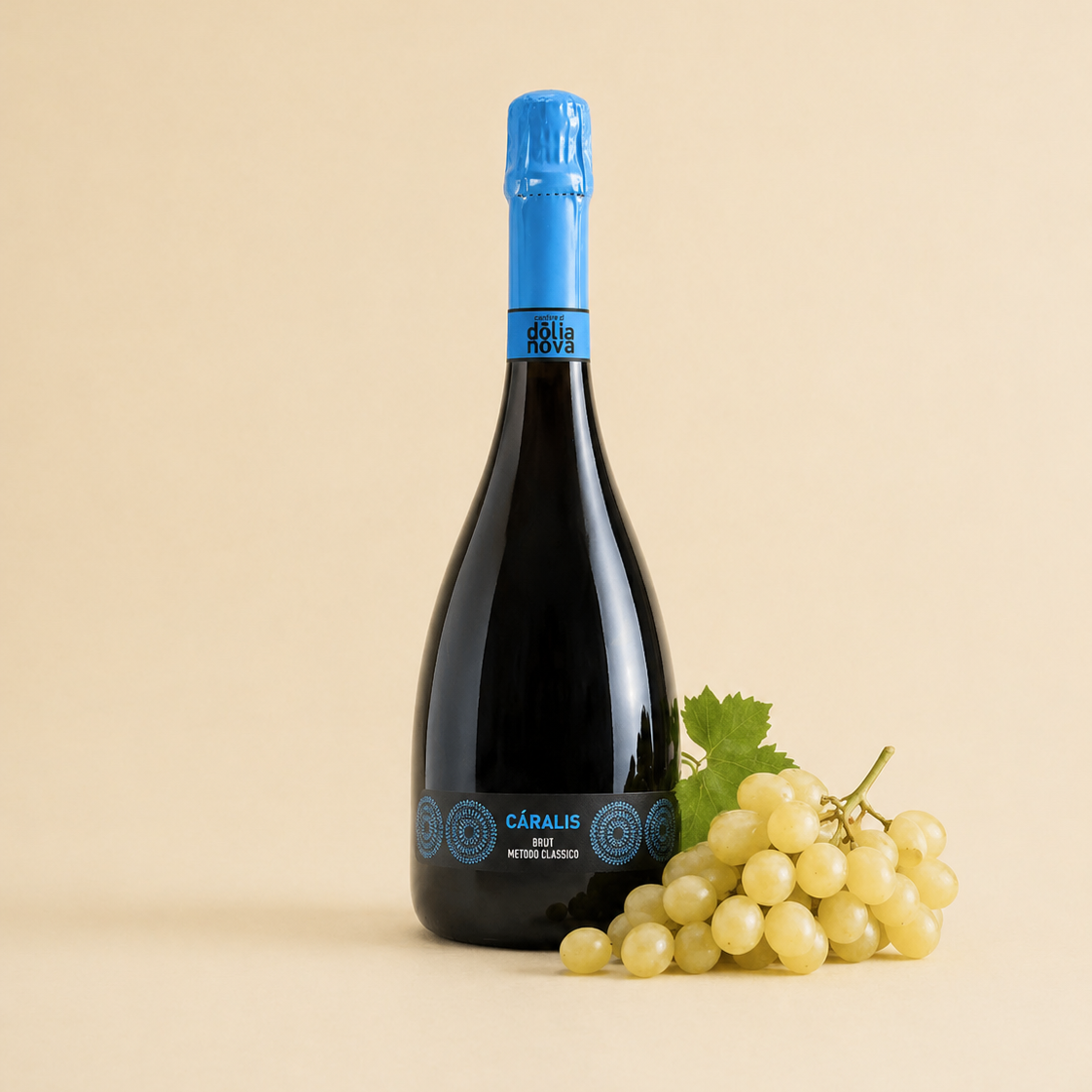 Càralis Vermentino brut sparkling wine bottle with fresh white grapes on a light background
