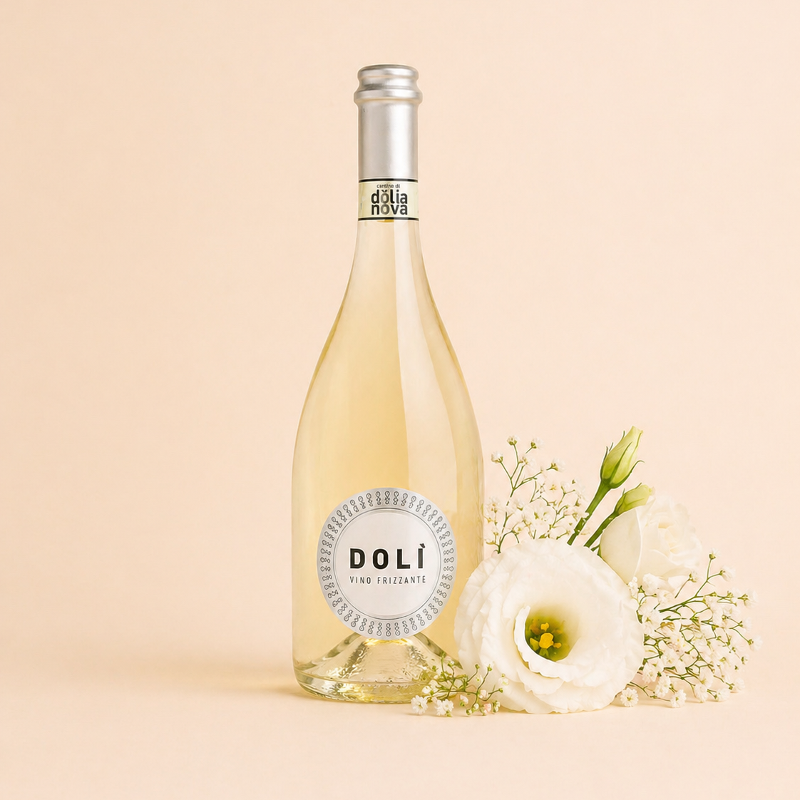 Dolì Bianco Frizzante Sardinian sparkling white wine bottle with white flowers on a soft neutral background