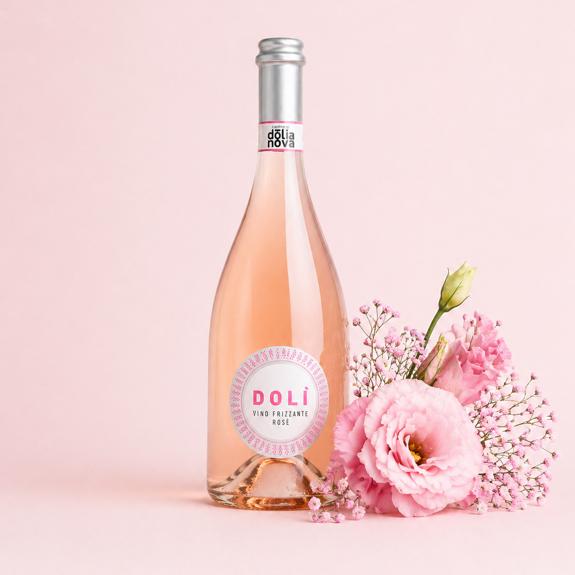 Dolì Rosé Frizzante Sardinian sparkling rosé wine bottle with pink flowers on a soft pastel background