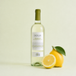 Dolia Vermentino di Sardegna DOC white wine with lemons on a light background, fresh citrus style Sardinian wine