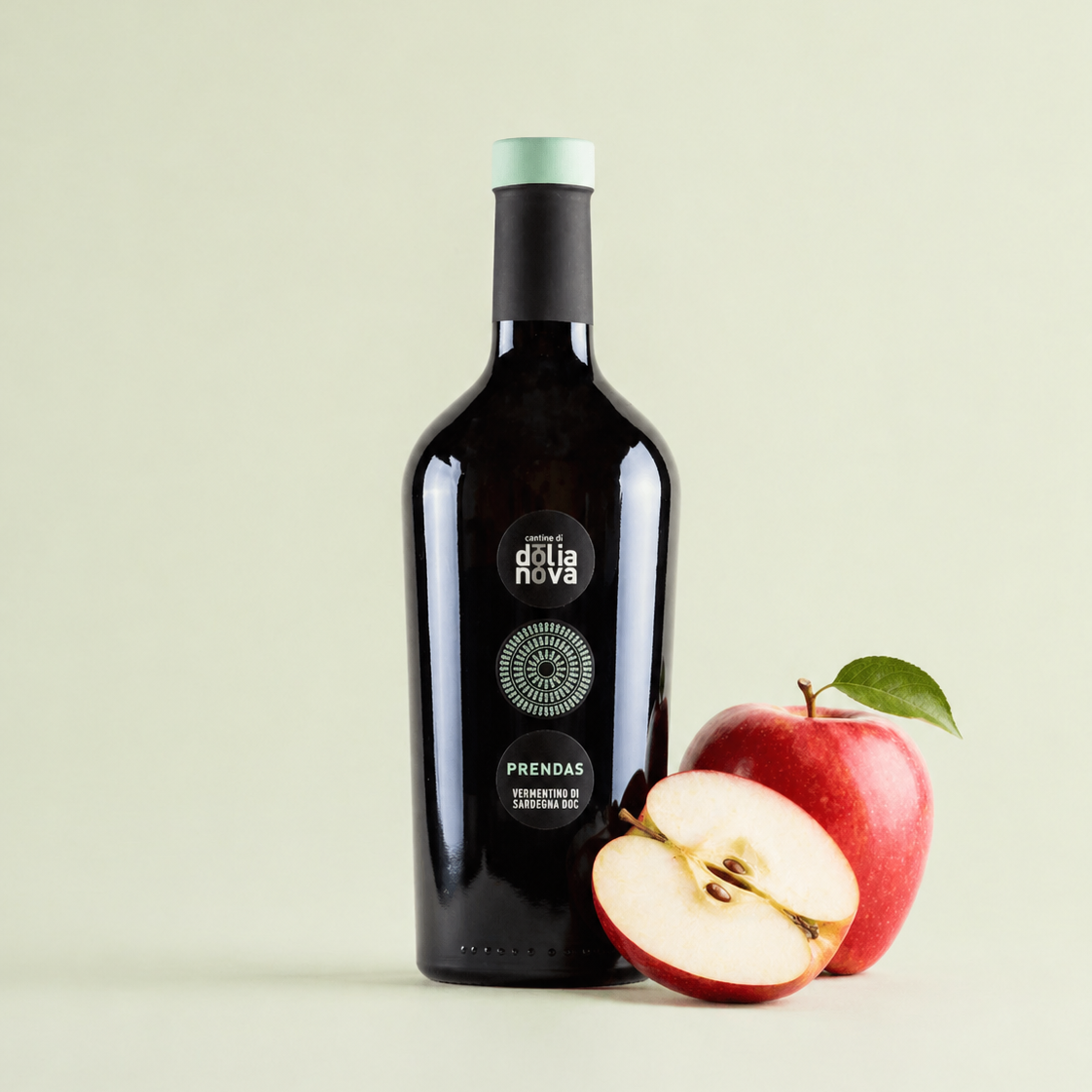 Prendas Vermentino di Sardegna white wine bottle with fresh apple on light green background