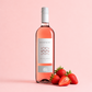 Santesu Rosato Sardinian rosé wine with strawberries on a soft pink background