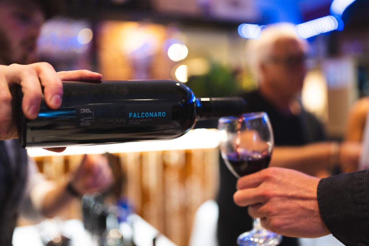 Falconaro Carignano being poured into a red wine glass
