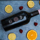 Rosada Cannonau di Sardegna DOC rosé wine bottle with citrus slices and raspberries